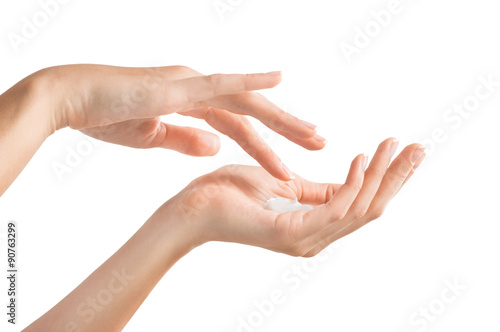 Female hands applying moisturiser