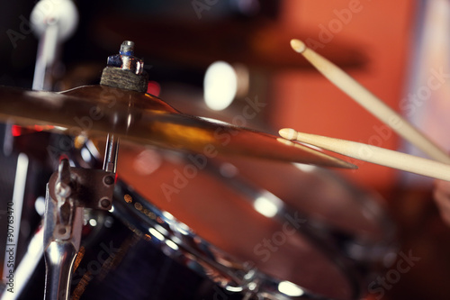 Hand of drummer with sticks and drums, close-up