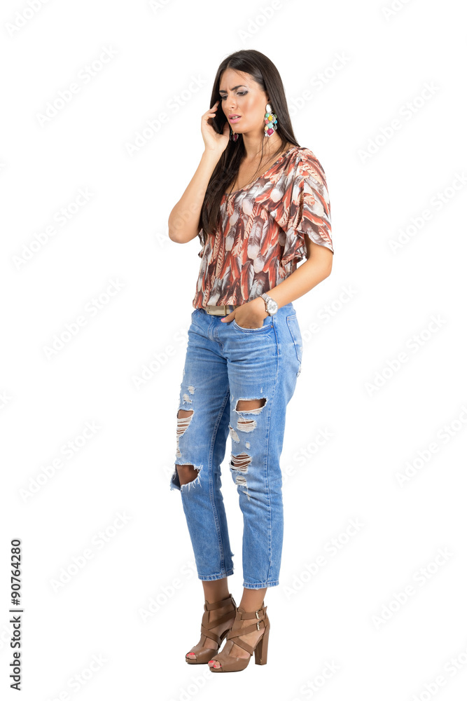 Upset young casual woman talking on the mobile phone. Upset young casual woman talking on the mobile phone.