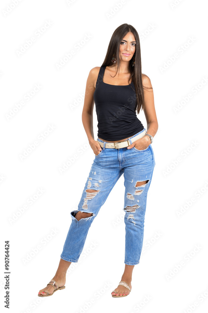 Fototapeta premium Young seductive Indian woman looking at camera with hands in pockets