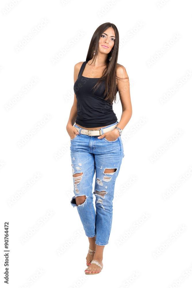Confident young sexy beauty with hands in pockets looking at camera. Confident young sexy beauty with hands in pockets looking at camera.
