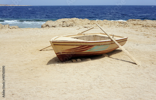 Lonely boat with oars in the coast