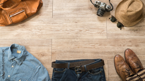 Top view of Vintage clothing and accessories on the wooden backg