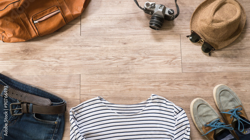 Top view of Vintage clothing and accessories on the wooden backg