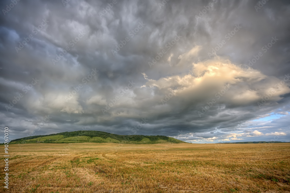Stormy cloudscape over the summer field