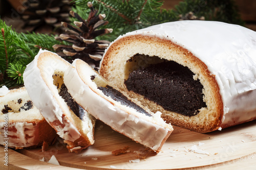 Christmas poppy seed roll, decorated with fir branches, cones, n