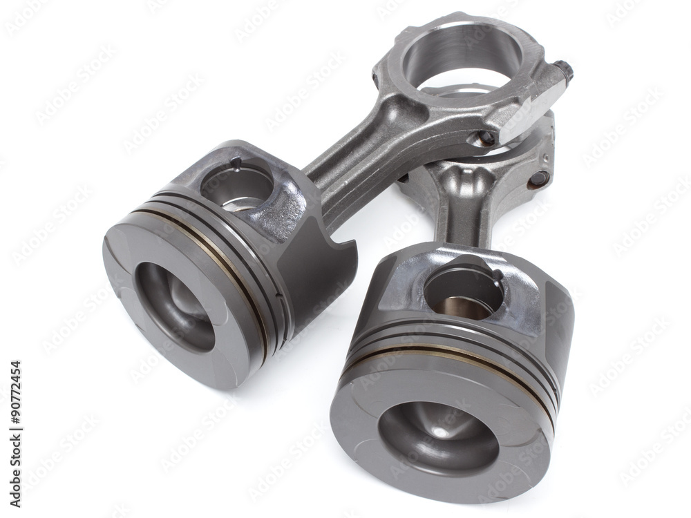 a set of pistons and rods for automobile engine on a white background a set of pistons and rods for automobile engine on a white background