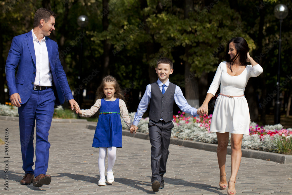 Happy Family Walking Along Suburban Street Happy Family Walking Along Suburban Street