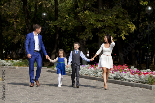 Happy Family Walking Along Suburban Street