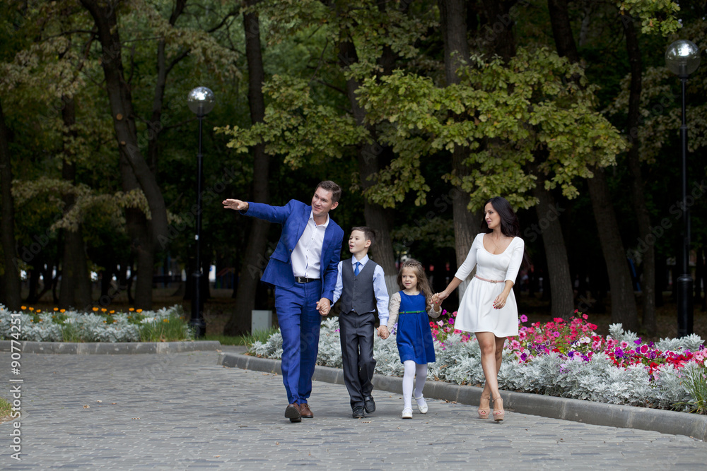 Obraz premium Happy Family Walking Along Suburban Street
