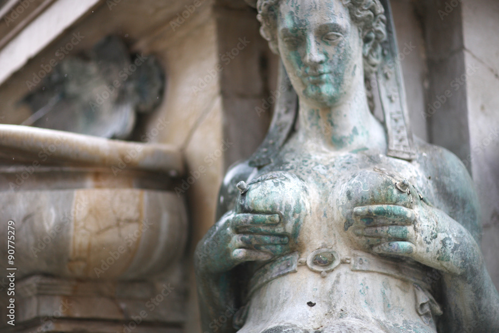 Sculpture of a woman pumping milk, the Fountain of Neptune, Bologna, Italy