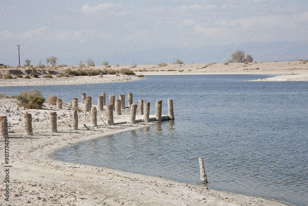 Naklejka premium Only broken pylons remain from the pier in the Salton Sea Marina in California.