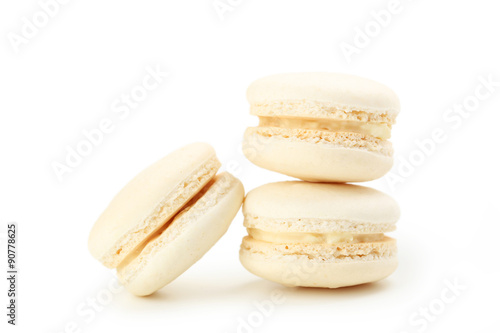 Tasty beige macarons isolated on white