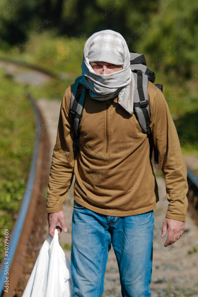 Man acting as a refugee on a railway Man acting as a refugee on a railway