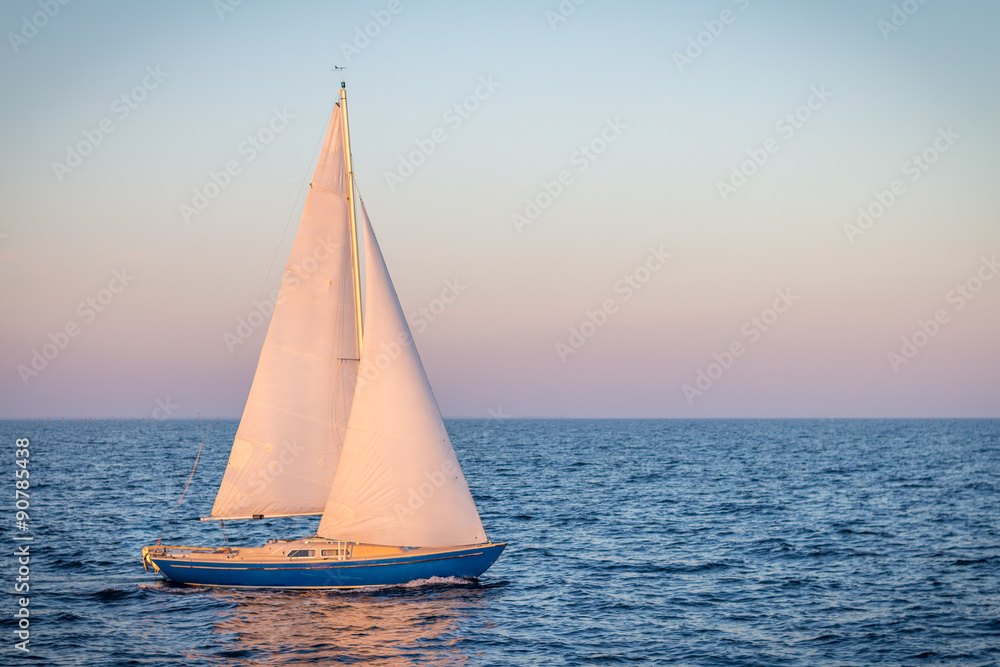 Obraz premium blue sailboat in the ocean