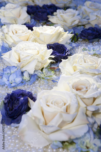 artificial white and blue roses on pearl beads