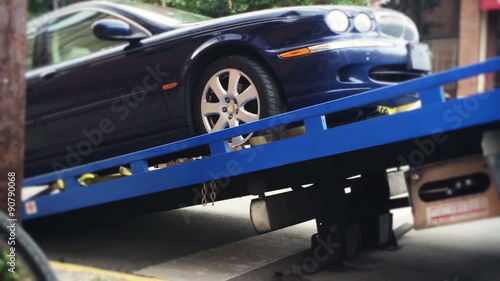 Car Gets Loaded onto a Tow Truck photo