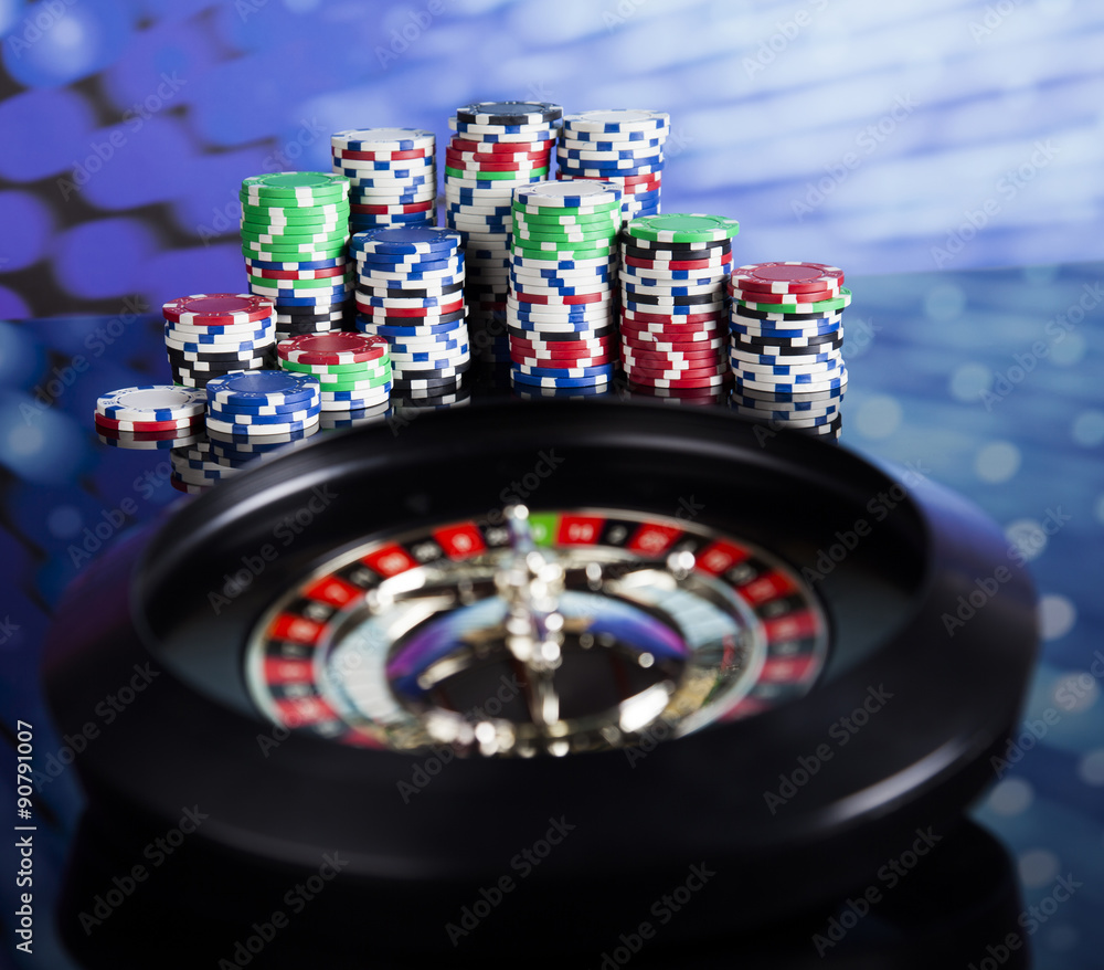 Poker Chips on a gaming with casino roulette Poker Chips on a gaming with casino roulette