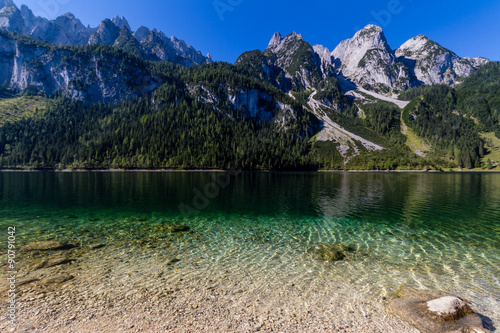 Beautiful landscape of alpine lake with crystal clear green water and mountains in background, Gosausee, Austria © daliu