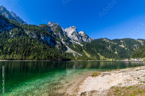 Beautiful landscape of alpine lake with crystal clear green water and mountains in background, Gosausee, Austria