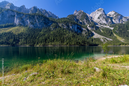 Beautiful landscape of alpine lake with crystal clear green water and mountains in background, Gosausee, Austria
