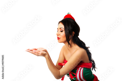 Woman wearing elf clothes blowing kiss