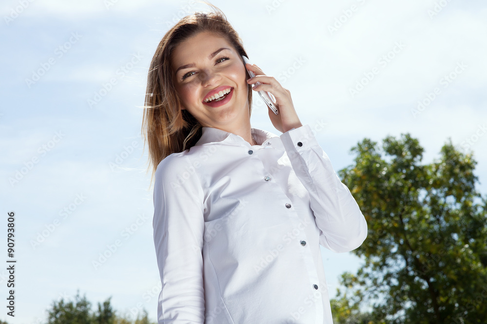 Portrait of smiling girl talking by mobile phone. Portrait of smiling girl talking by mobile phone.