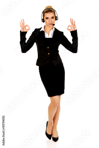 Happy businesswoman shows OK sign