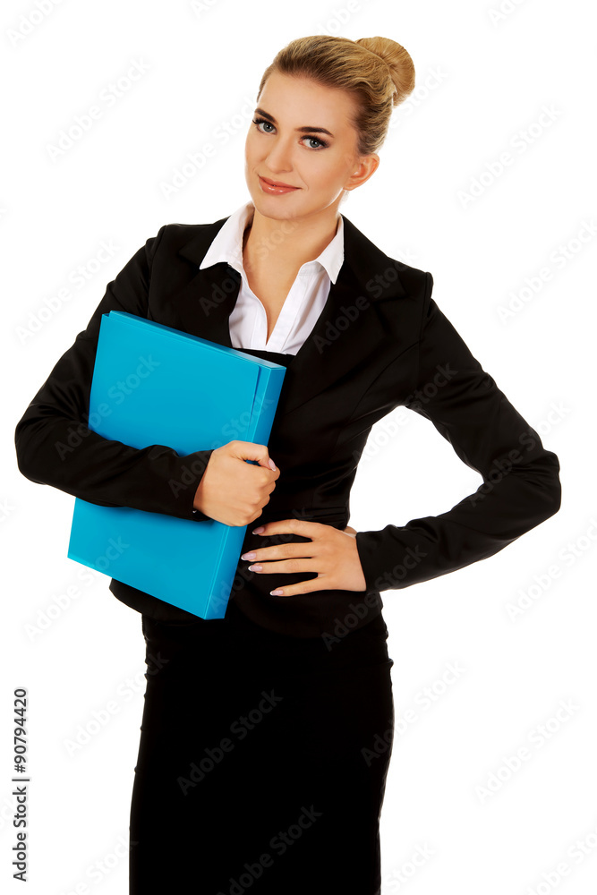 Smiling businesswoman holding a binder Smiling businesswoman holding a binder