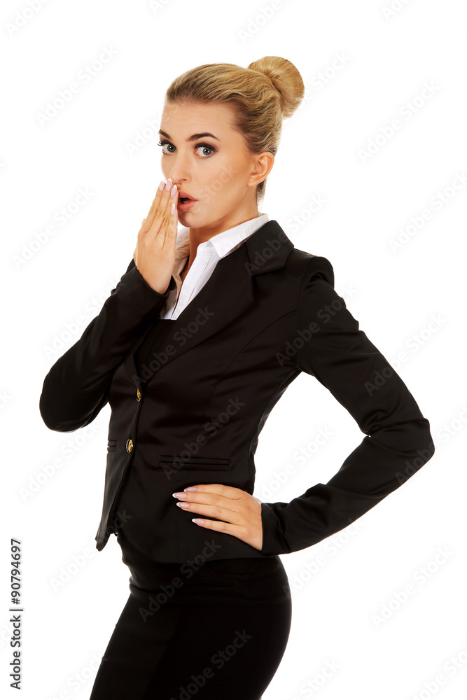 Young shocked businesswoman covering mouth Young shocked businesswoman covering mouth