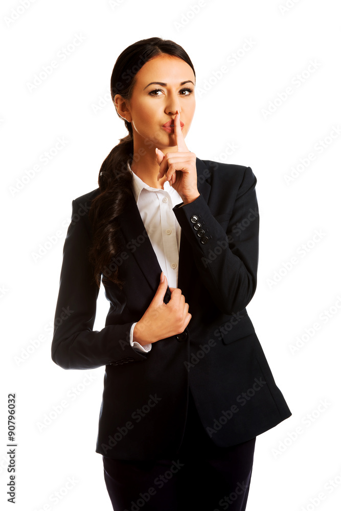 Businesswoman making silent sign Businesswoman making silent sign