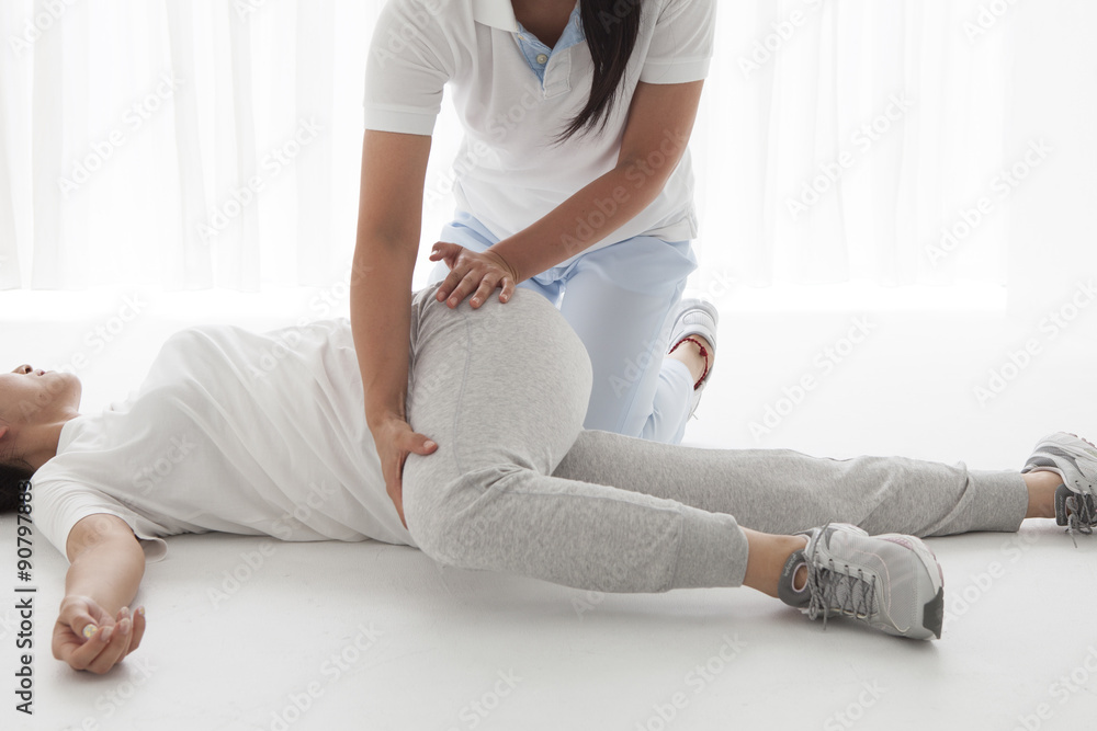 Physio Therapist have stretch a woman's waist - obrazy, fototapety, plakaty 