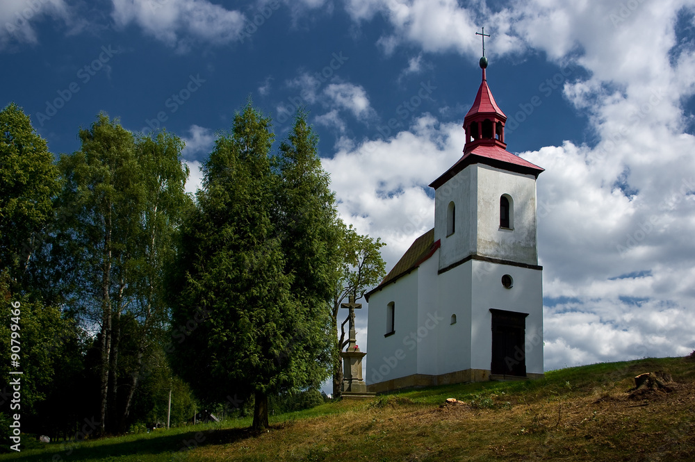 A small Catholic church standing in the landscape.