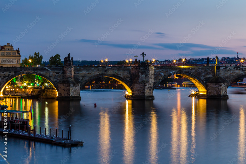 Reflection of Prague castle and the Charles bridge at dusk