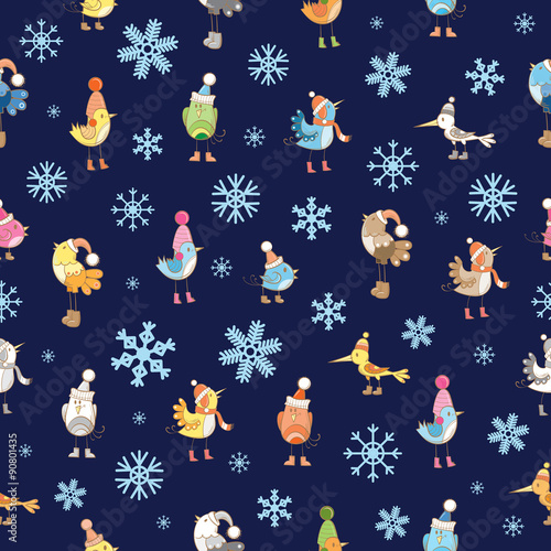 Vector seamless winter pattern with cute cartoon birdies in knitted caps on a blue background.