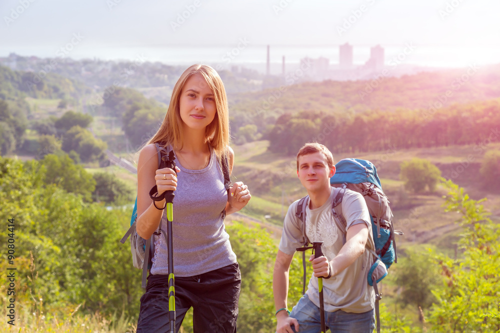 Excited Hikers Young Man Woman Traveling Outdoor Expressing Fun and Pleasure with Backpacks Walking Poles Sticks and Casual Sporty Style Clothing Forest Suburban Park Landscape Sunrise Sun Background Excited Hikers Young Man Woman Traveling Outdoor Expressing Fun and Pleasure with Backpacks Walking Poles Sticks and Casual Sporty Style Clothing Forest Suburban Park Landscape Sunrise Sun Background