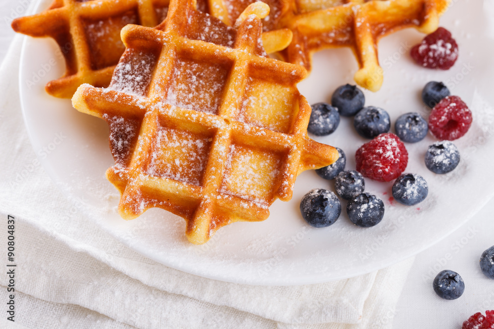 Belgian waffles with milk and fresh berries.selective focus Belgian waffles with milk and fresh berries.selective focus
