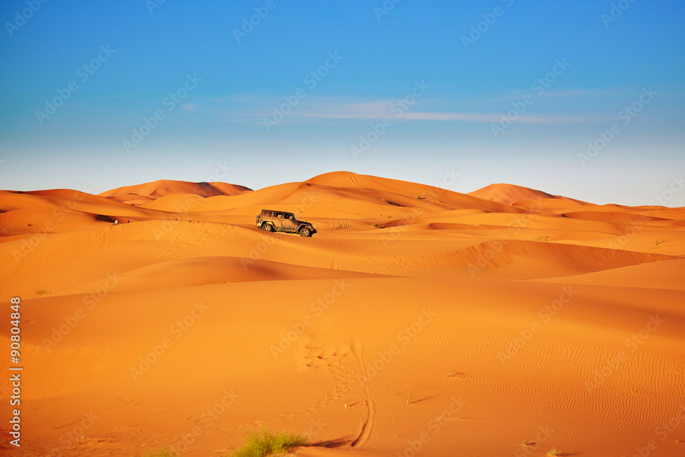 Jeep in sand dunes in the Sahara Desert, Morocco