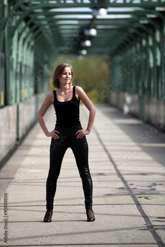 Young beautiful woman posing on a bridge © ginkgofoto