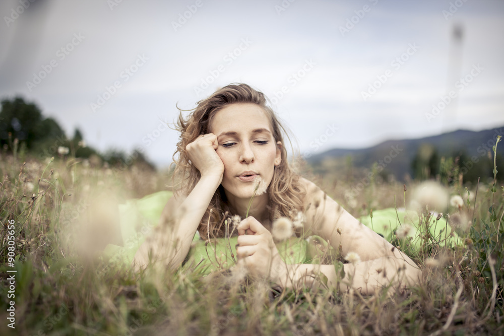 Happy woman relaxing on meadow. Beautiful summer day on field. Happy woman relaxing on meadow. Beautiful summer day on field.
