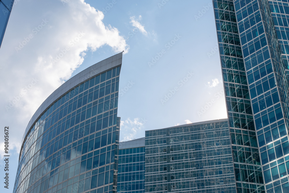 High-rise buildings on blue sky with clouds