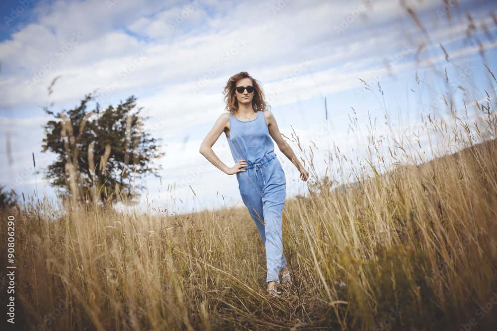 beautiful young woman posing on a meadow. Summer fashion photo. Lifestyle beautiful young woman posing on a meadow. Summer fashion photo. Lifestyle