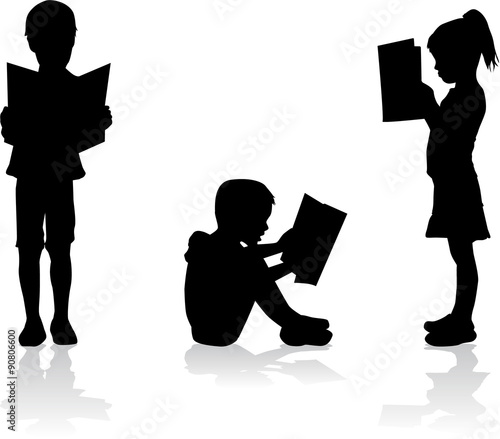Silhouette of a child reading a book at.