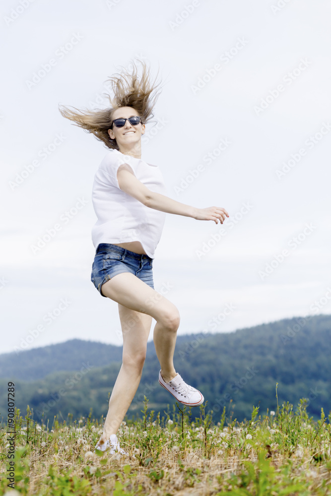 Happy woman jumping on meadow. Beautiful summer day on field. Happy woman jumping on meadow. Beautiful summer day on field.