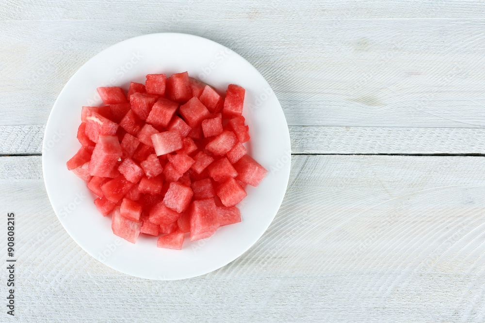 watermelon on a plate on a wooden background watermelon on a plate on a wooden background