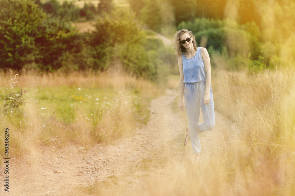 beautiful young woman posing on a meadow. Summer fashion photo. Lifestyle