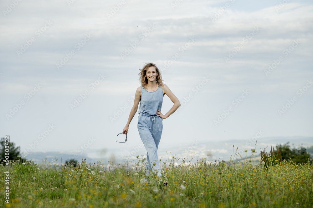 beautiful young woman posing on a meadow. Summer fashion photo. Lifestyle beautiful young woman posing on a meadow. Summer fashion photo. Lifestyle