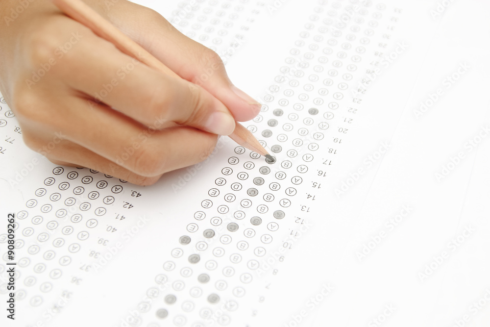 Obraz premium Standardized test form with answers bubbled in and a pencil, foc