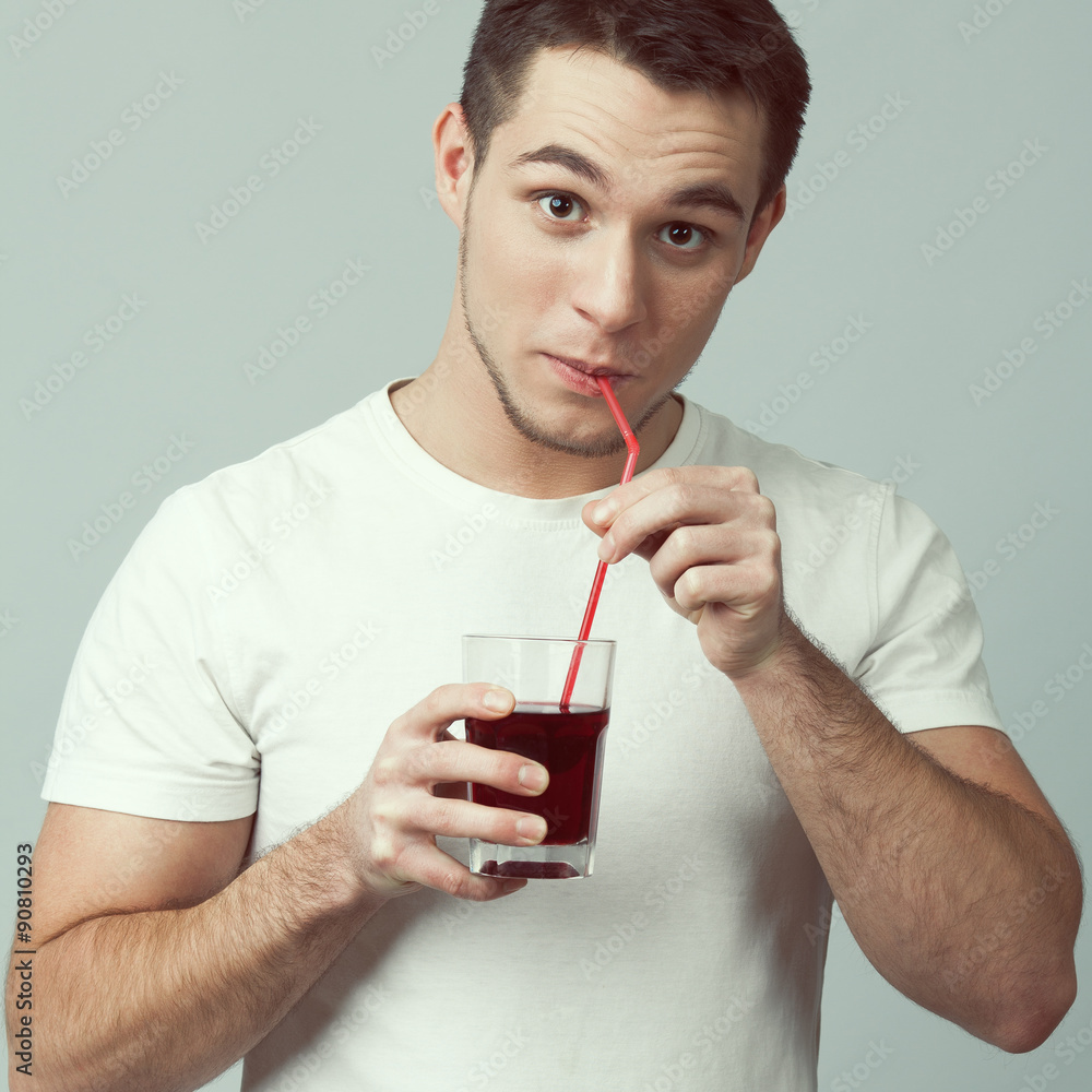 Portrait of happy funny young muscled man drinking grape juice Stock Photo  | Adobe Stock