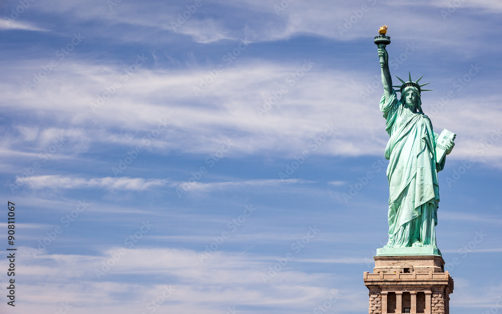 Fototapeta premium Statue of Liberty, NYC, USA. A view of the familiar New York landmark set against a bright blue spring sky with copy space.